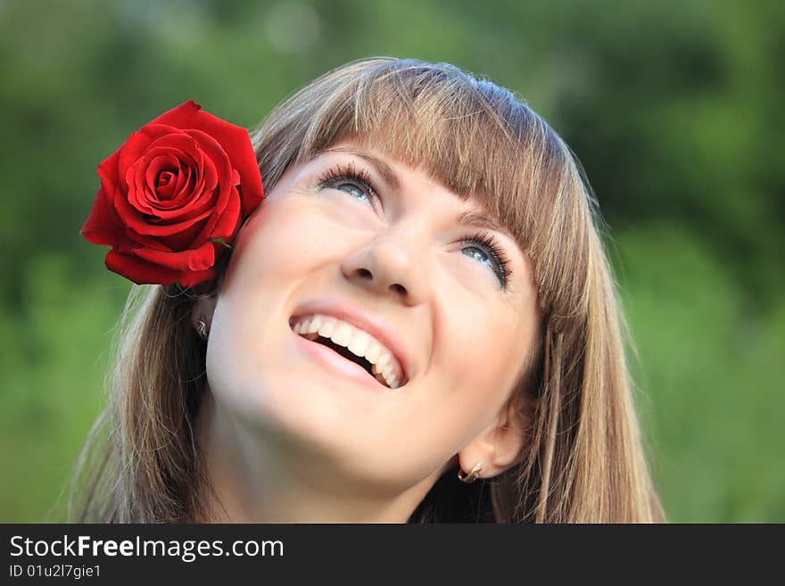 Girl With Rose In Hair Looks Upwards