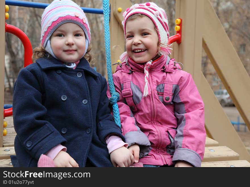 Two smiling little girls on playground. Two smiling little girls on playground