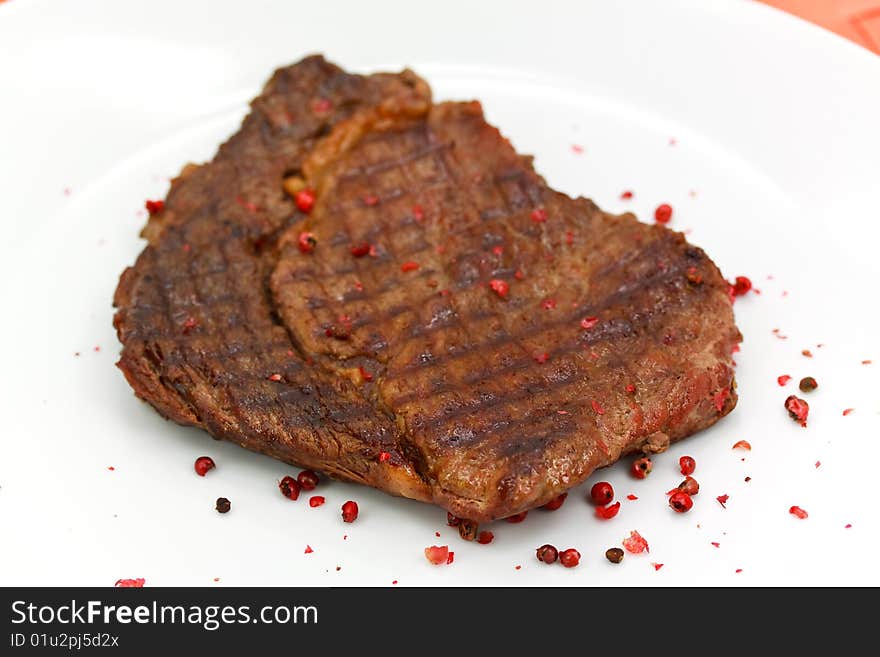 Rib Eye Steak on the white Plate.