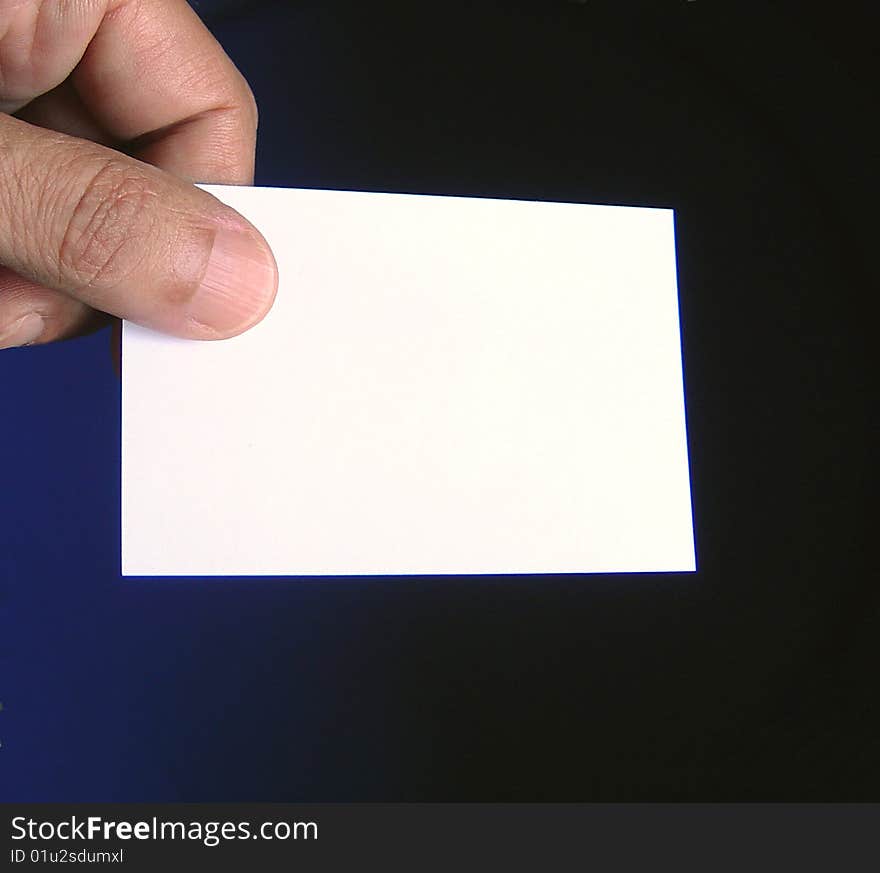 Close up view of fingers holding a  business card free to write what you want on it. Close up view of fingers holding a  business card free to write what you want on it