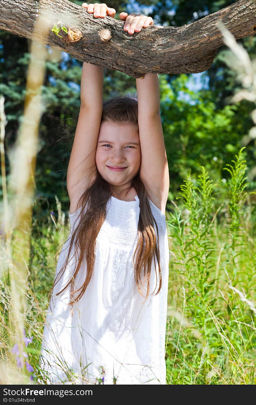 The girl in a white dress hangs on a tree. The girl in a white dress hangs on a tree