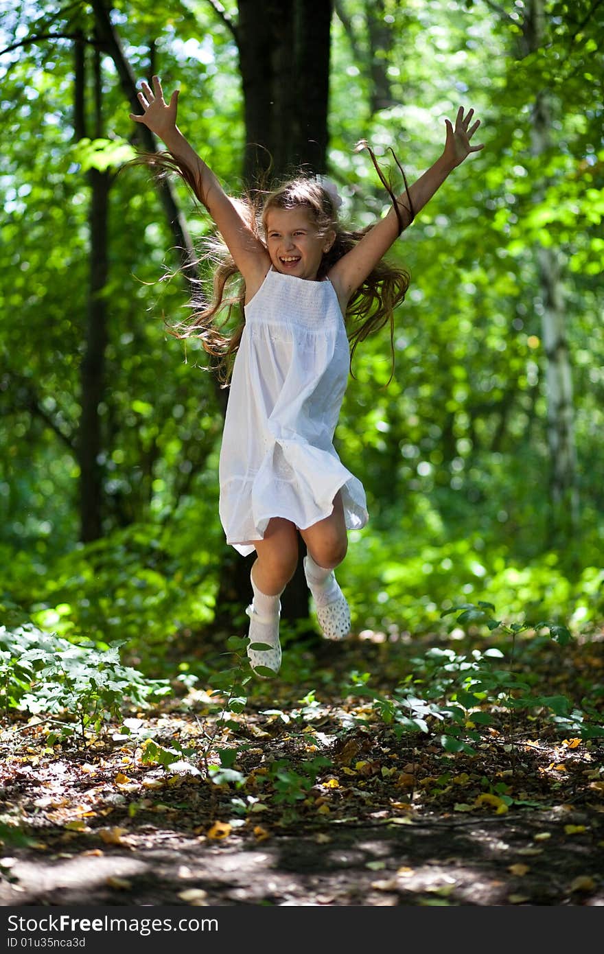 Girl Joyfully Jumps In The Wood