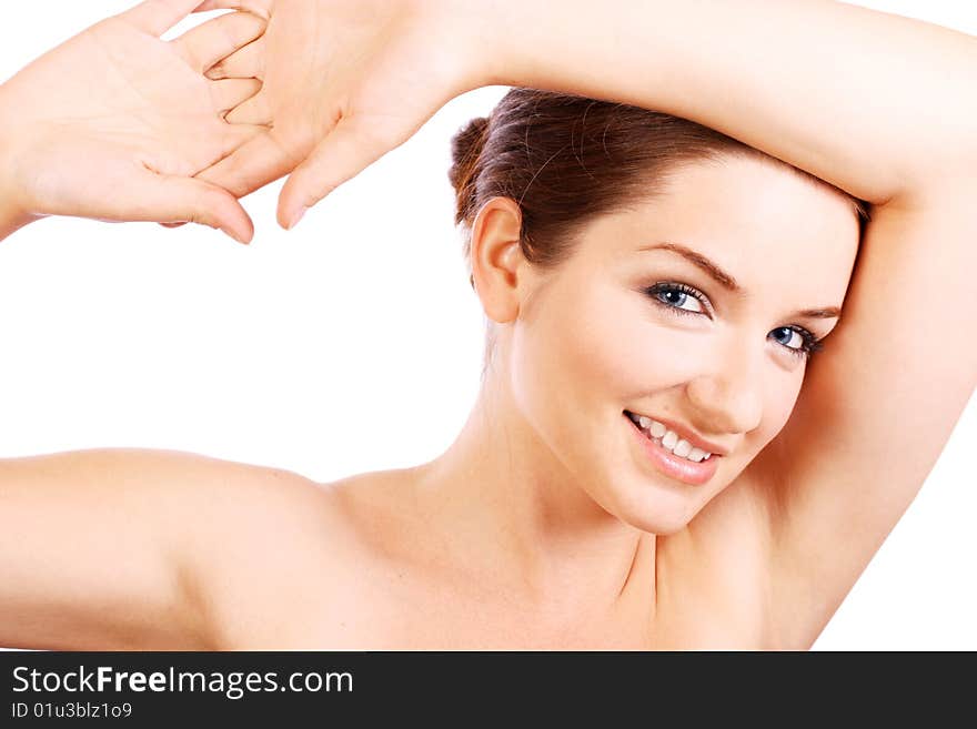 A beautiful confident woman smiling at the camera in front of a white background.