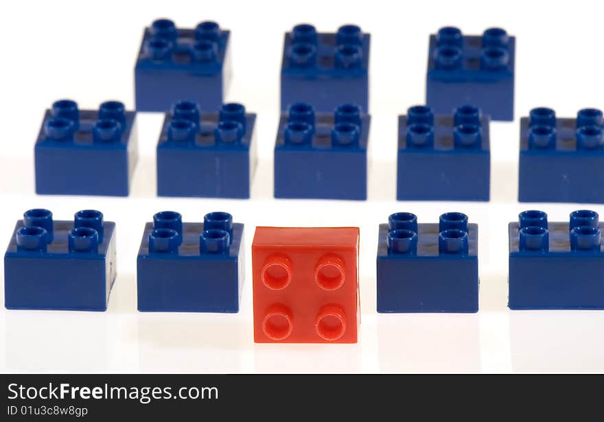 Battalion of toy blocks, one red block at head of blue block team. Battalion of toy blocks, one red block at head of blue block team