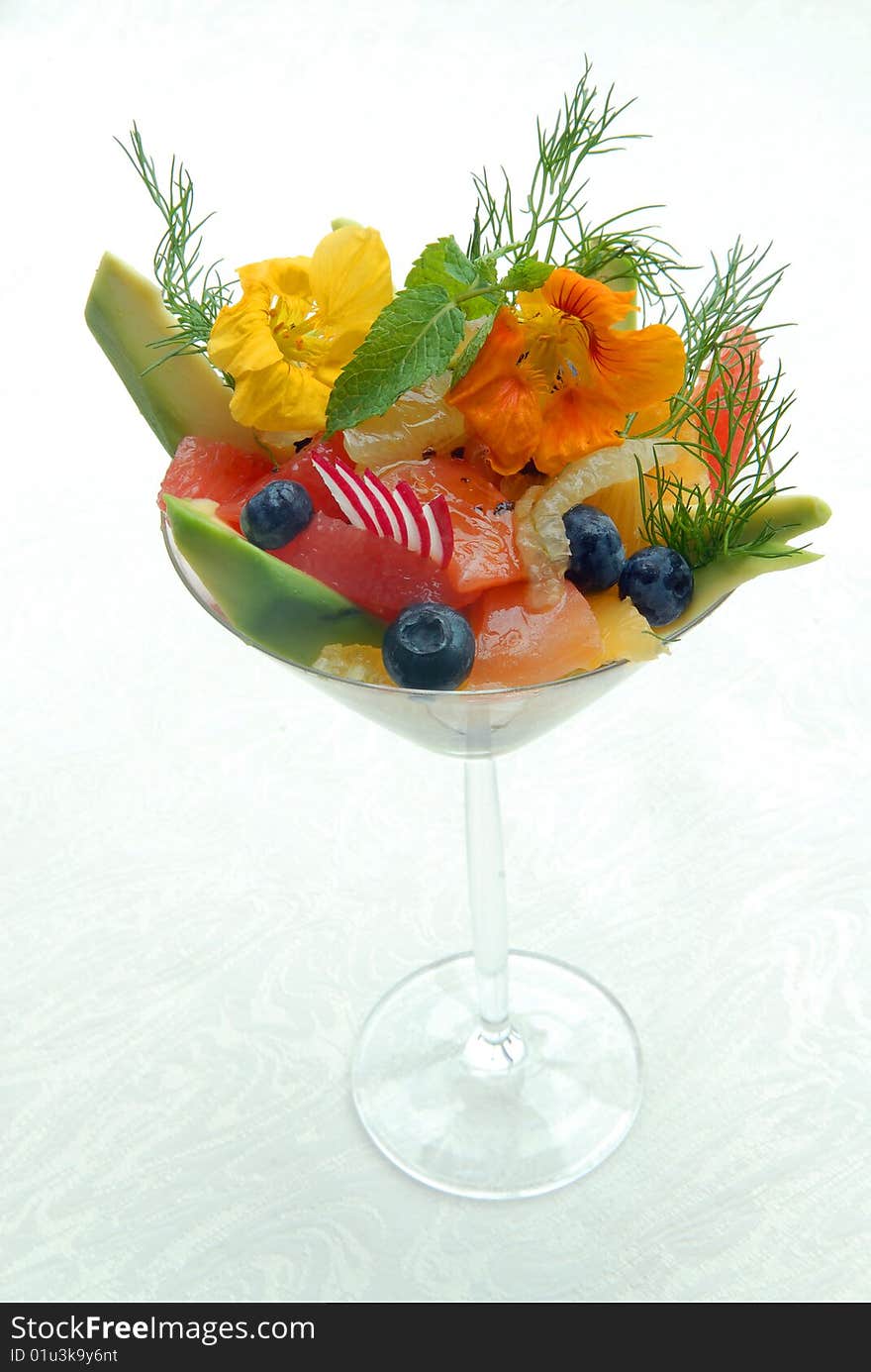 Fruit salad in a glass on a white cloth