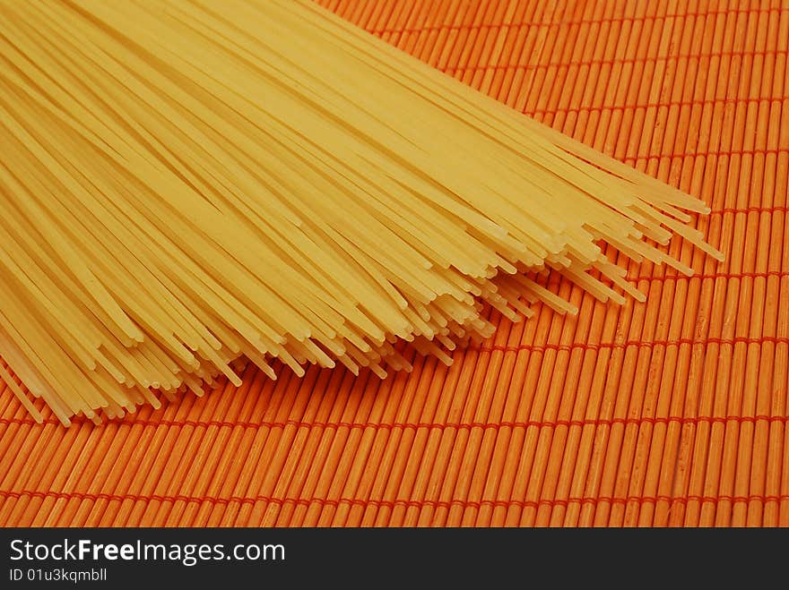 Pasta over orange bamboo mat