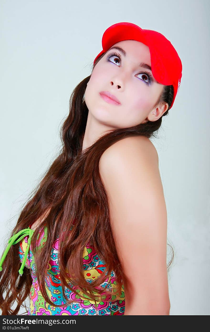 Young girl in red cap looking up