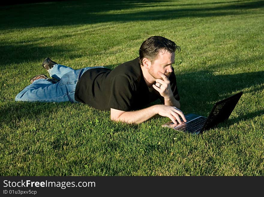 Man Working with Laptop in Park