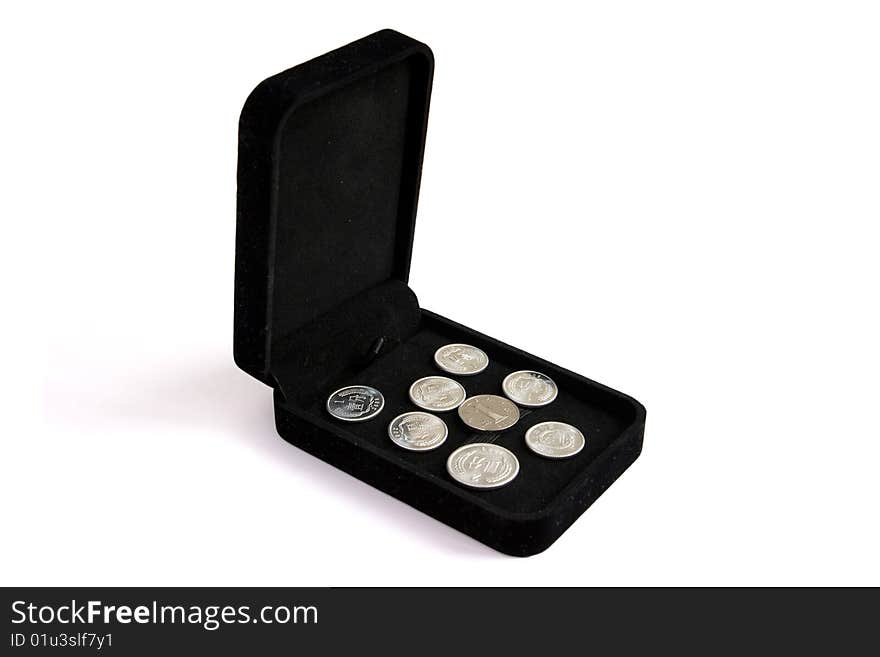 Chinese coins in a black jewelry box isolated on white. Chinese coins in a black jewelry box isolated on white