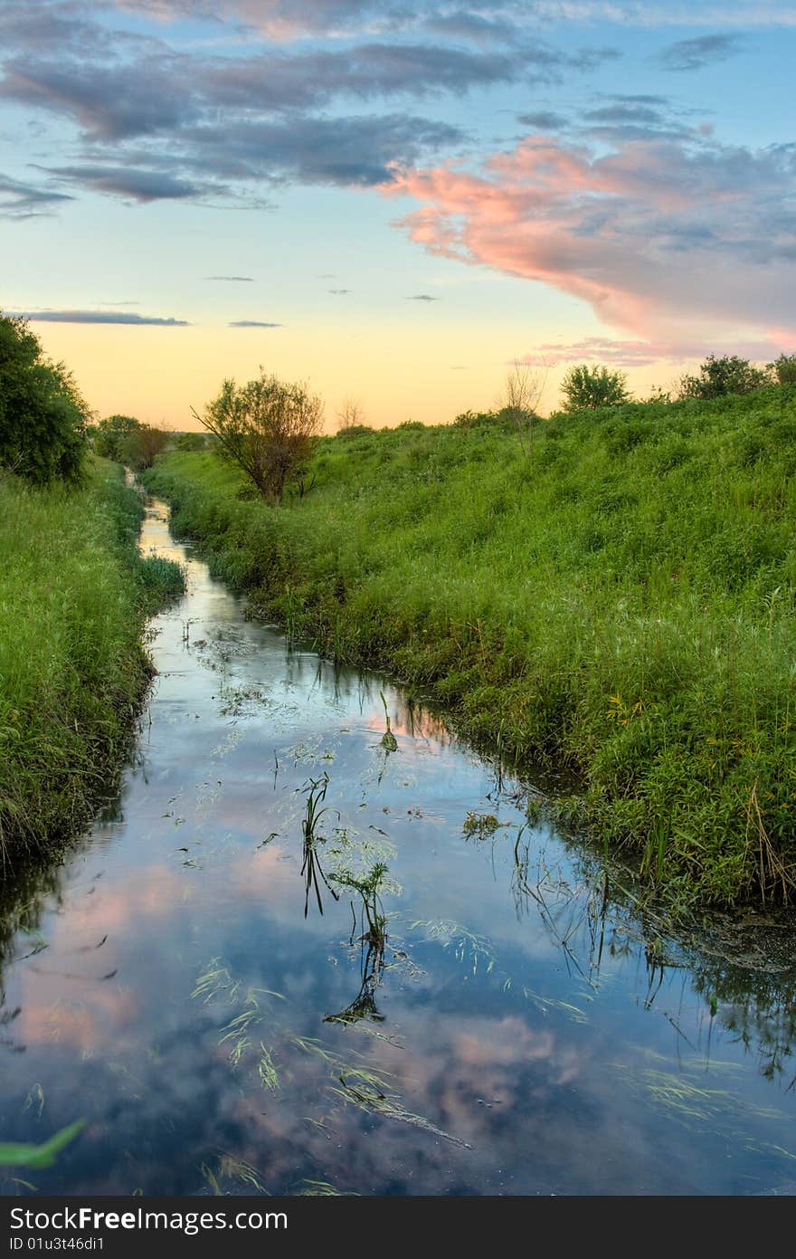 Sunset above the stream vertical