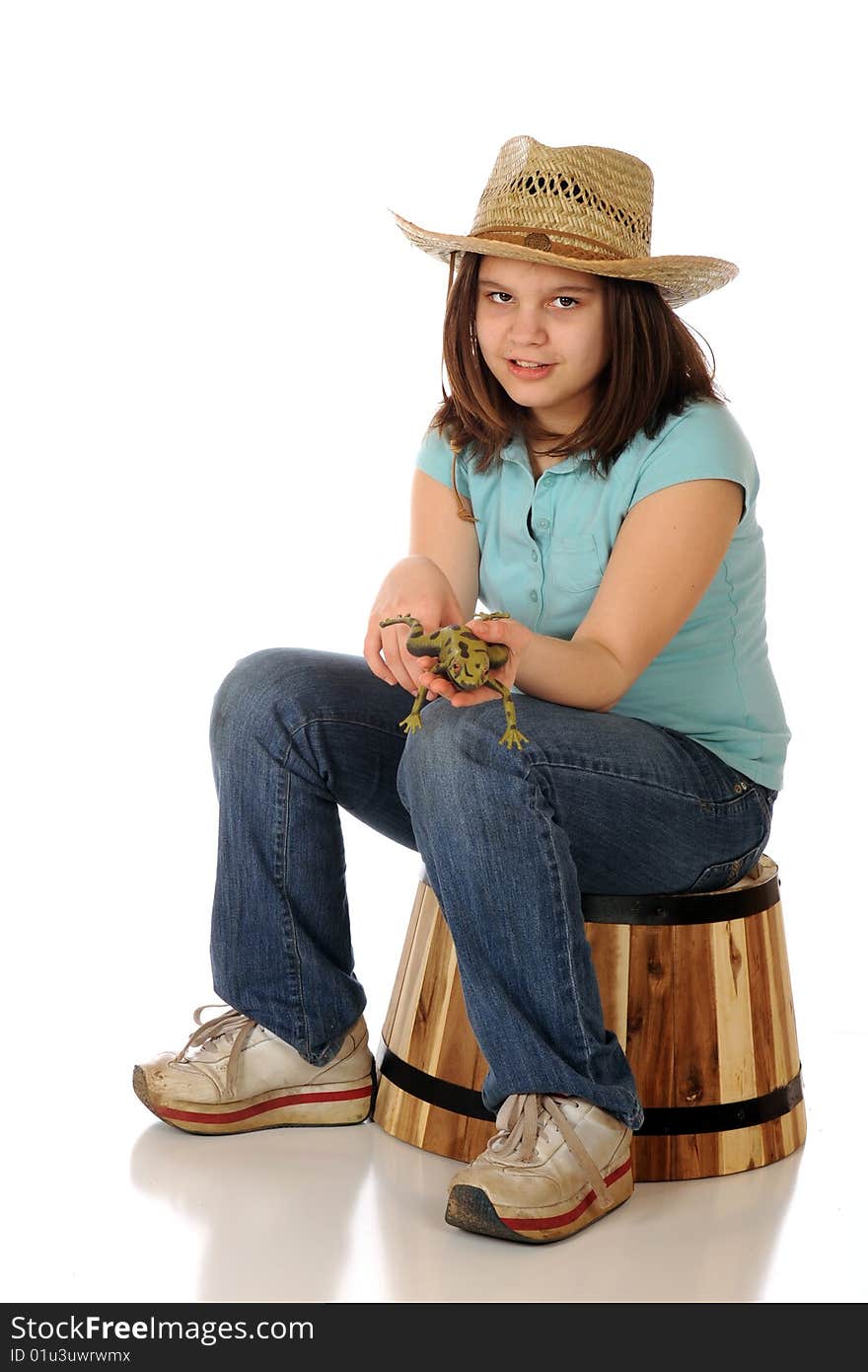 A reteen farm girl showing the viewer a green, spotted frog. Isolated on white. A reteen farm girl showing the viewer a green, spotted frog. Isolated on white.