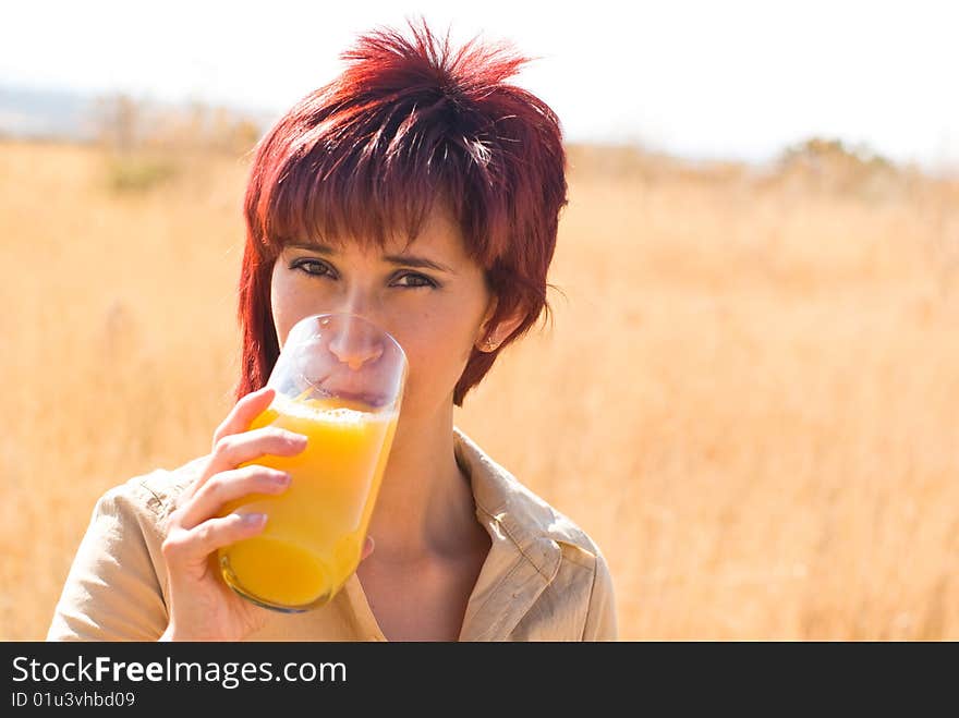 Woman tastes a glass of orange juice. Woman tastes a glass of orange juice