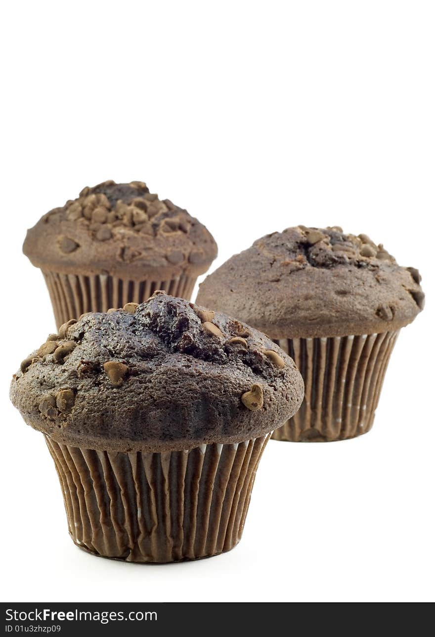 Three Chocolate Muffins with shallow depth of field, isolated on white, vertical with copy space