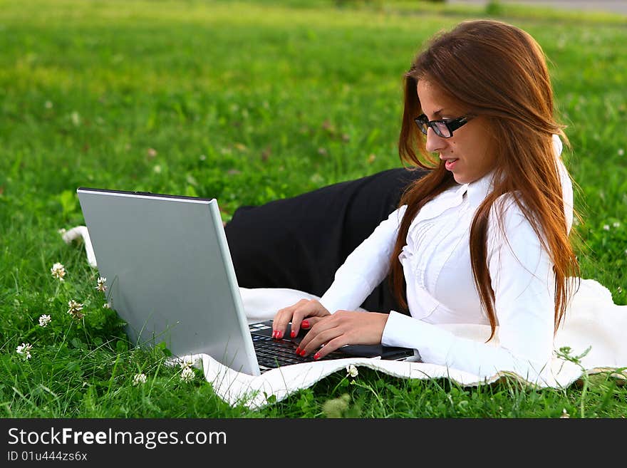 Beautiful young woman studing in park