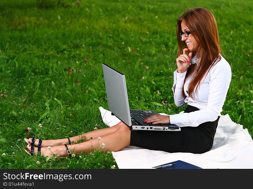 Beautiful young woman studing in park