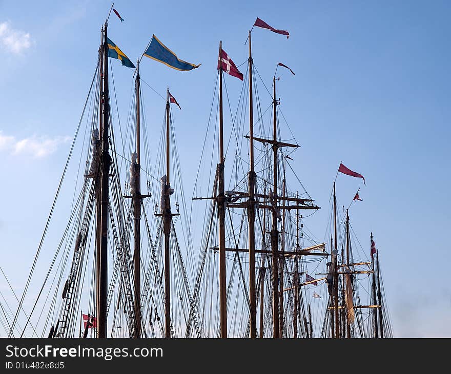 Sailing background line of masts of wooden tall ships