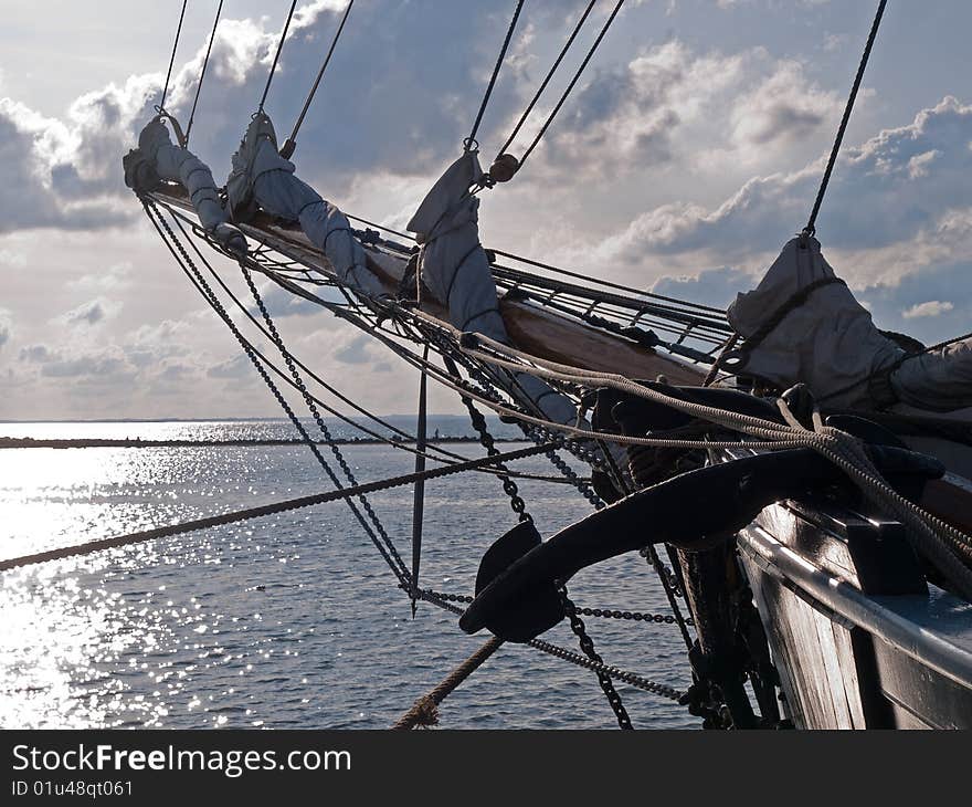 Traditional wood sailboat sailing out