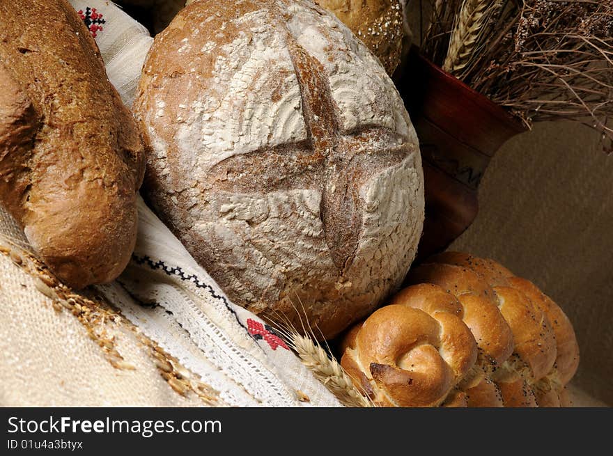 Isolated bread and vase with plants and grain