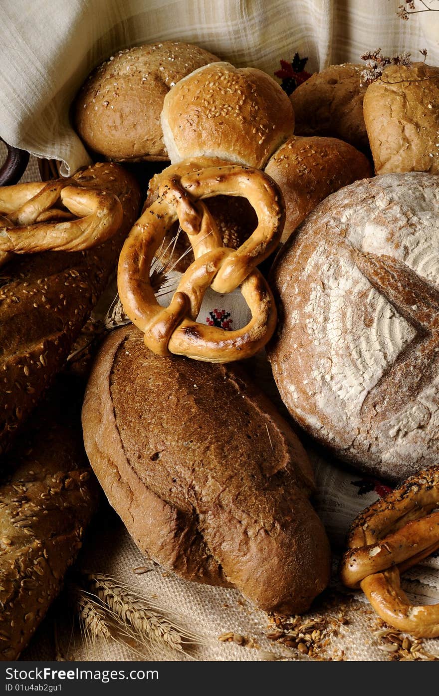 Isolated bread and tasty pretzel with grain and seeds around