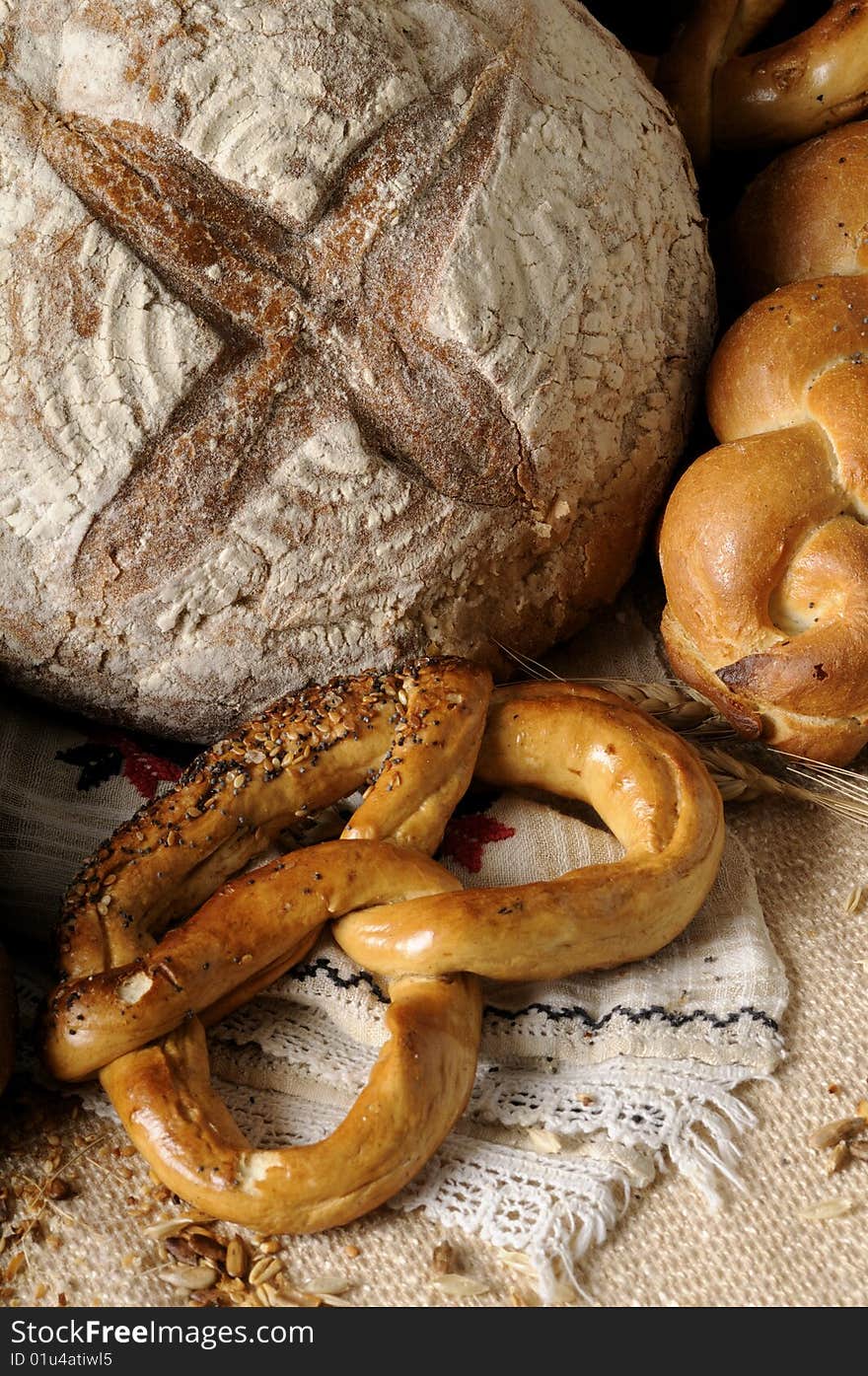 Isolated bread and tasty pretzel with grain and seeds around. Isolated bread and tasty pretzel with grain and seeds around