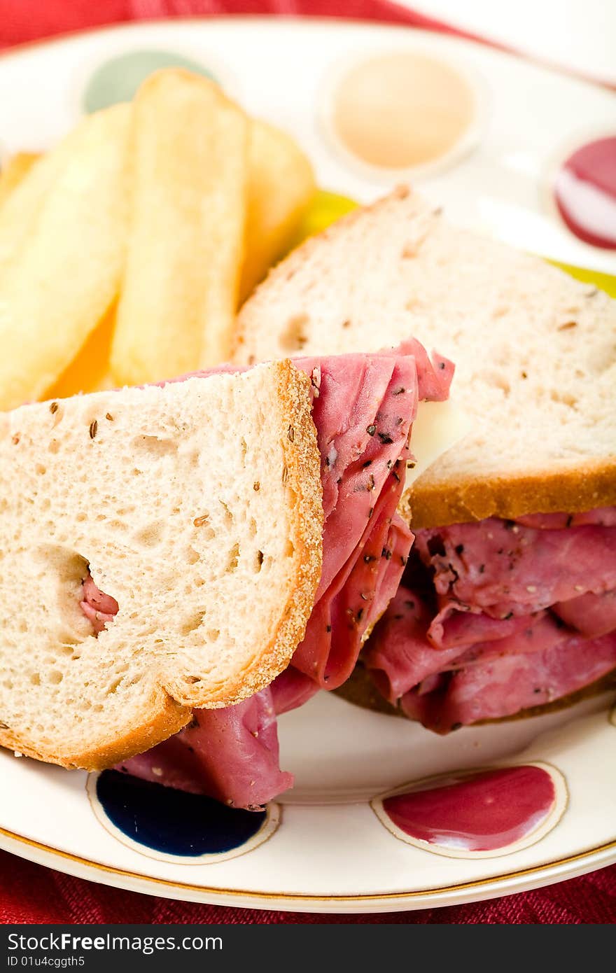 Pastrami sandwich with thick french fries and pickle. Pastrami sandwich with thick french fries and pickle