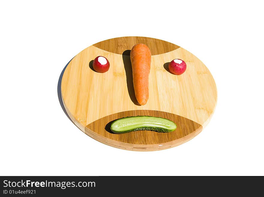 Smiley (emoticon) from vegetables on round cutting board. Smiley (emoticon) from vegetables on round cutting board