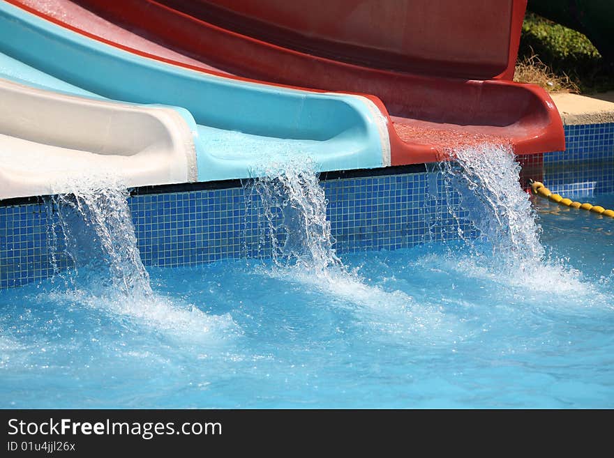 Water stream down on coloured water slides.