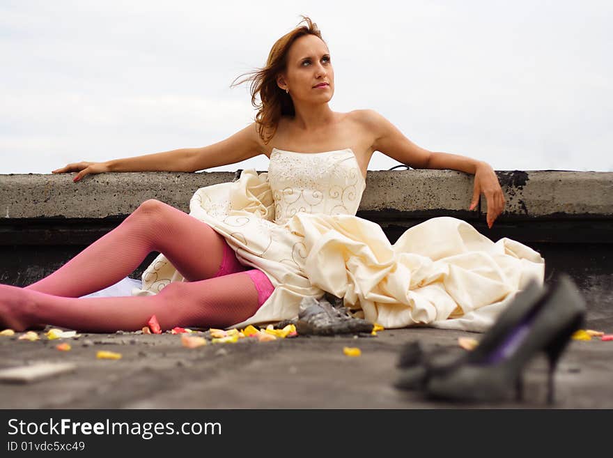 Woman in a wedding dress and in pink stockings. Woman in a wedding dress and in pink stockings