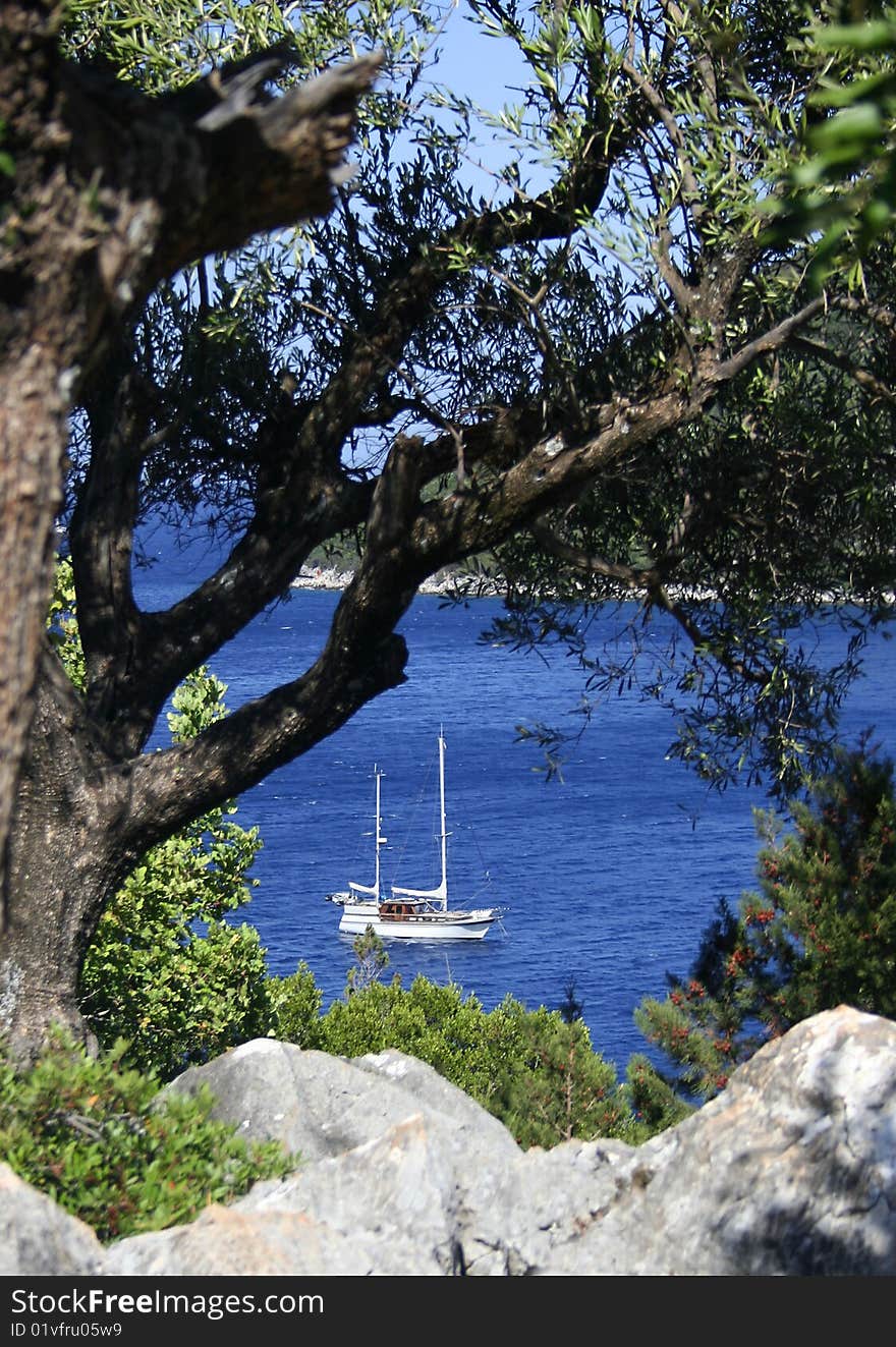 Hideaway sailboat on a blue sea bay. Hideaway sailboat on a blue sea bay