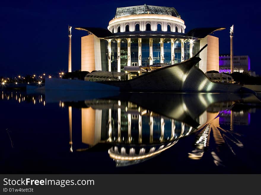 Hungarian national theater reflecting in water at night. Hungarian national theater reflecting in water at night