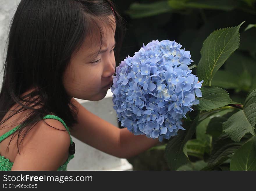 Asian Chinese Girl smelling flower