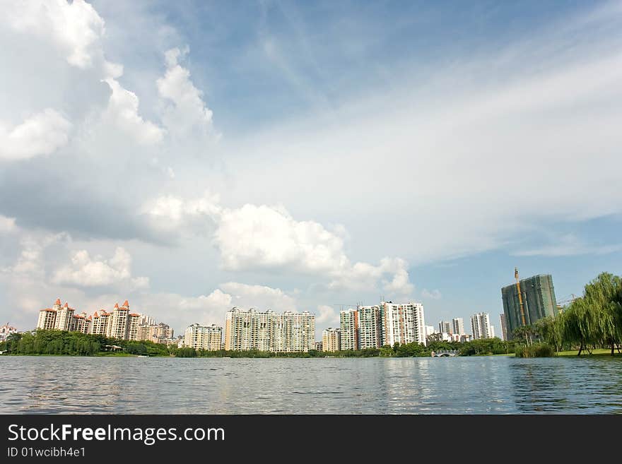 Chinese peaceful community with some modern buildings beside the lake in a beautiful day,Foshan,Canton,China. Chinese peaceful community with some modern buildings beside the lake in a beautiful day,Foshan,Canton,China