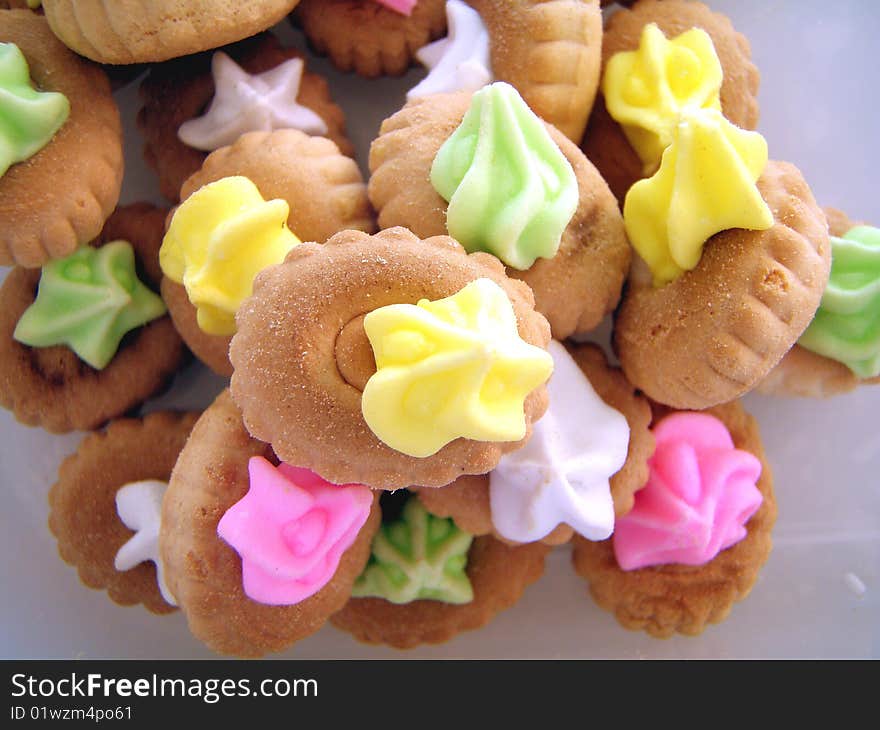 Cookies With Colorful Cream On Top.