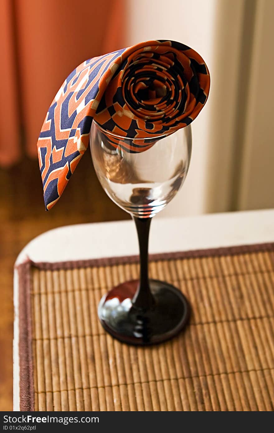 Empty wine glass with a stylish tie. Empty wine glass with a stylish tie.