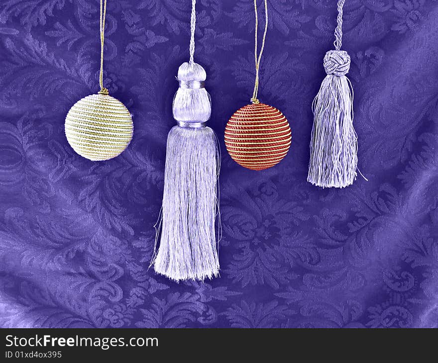 Silver Tassels and Christmas balls on a purple background. Silver Tassels and Christmas balls on a purple background