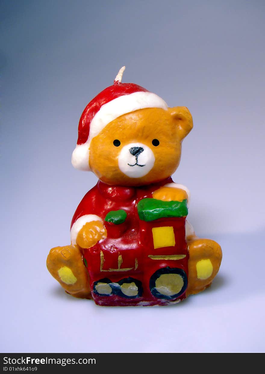 Candle of a cute teddy bear waiting christmas time. Candle of a cute teddy bear waiting christmas time