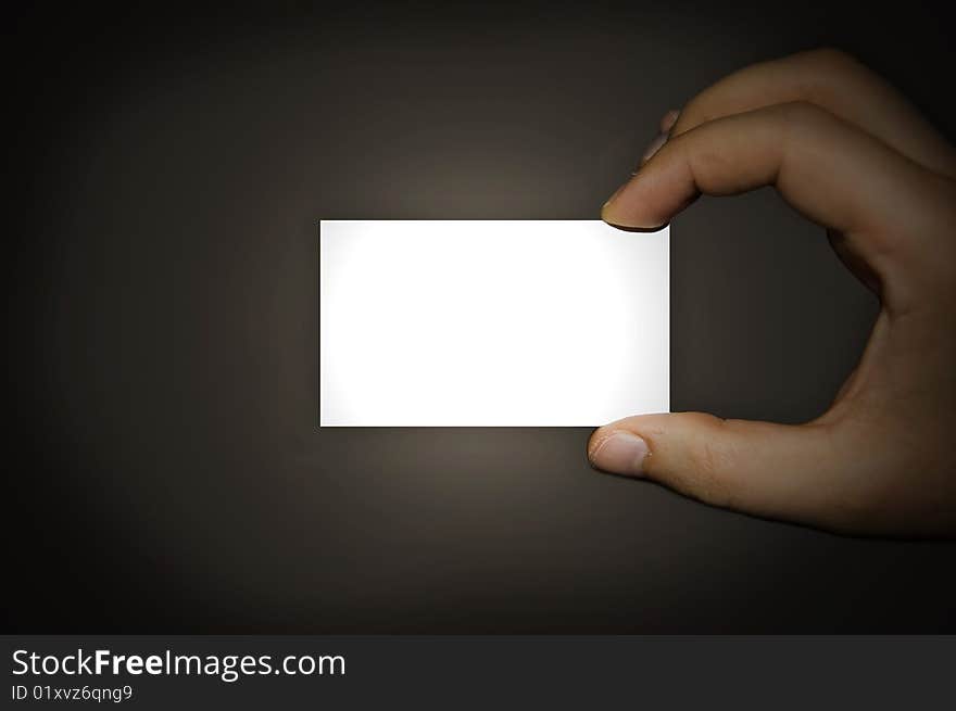 A man holding a business card