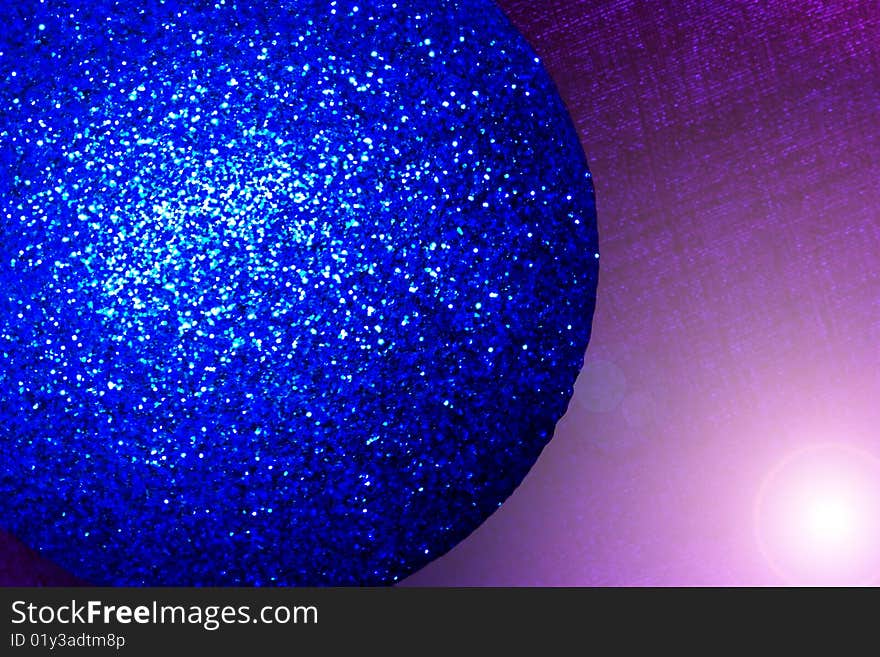 An extreme close-up of a blue christmas bauble. An extreme close-up of a blue christmas bauble