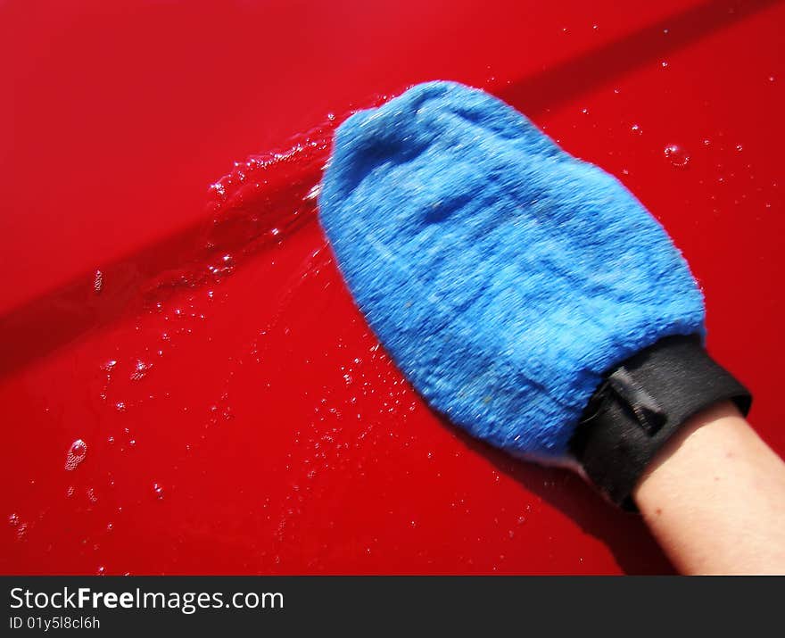 Washing the car with soap and quality blue glove. Washing the car with soap and quality blue glove.