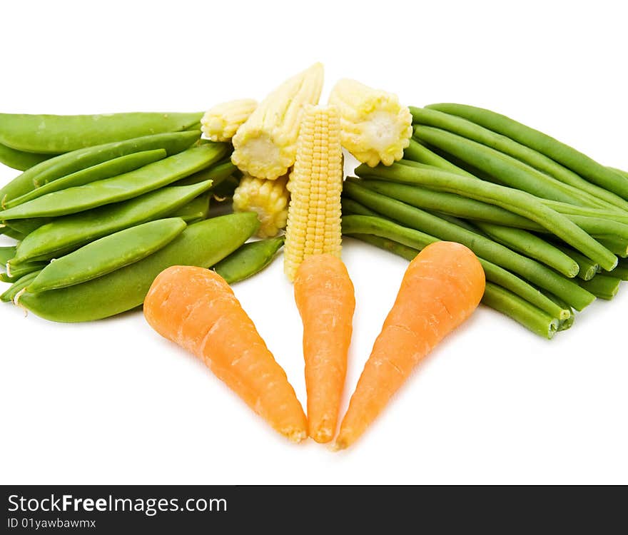 Healthy cooking with fresh vegetables - baby corn, beans and carrots. Isolated on white background. Healthy cooking with fresh vegetables - baby corn, beans and carrots. Isolated on white background.