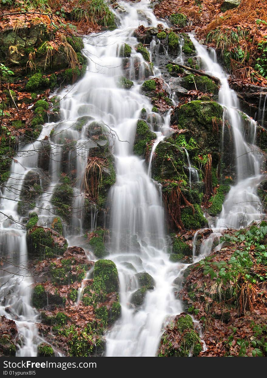 A little waterfall(cascade) in the mountains , shot at a slow shutter speed.