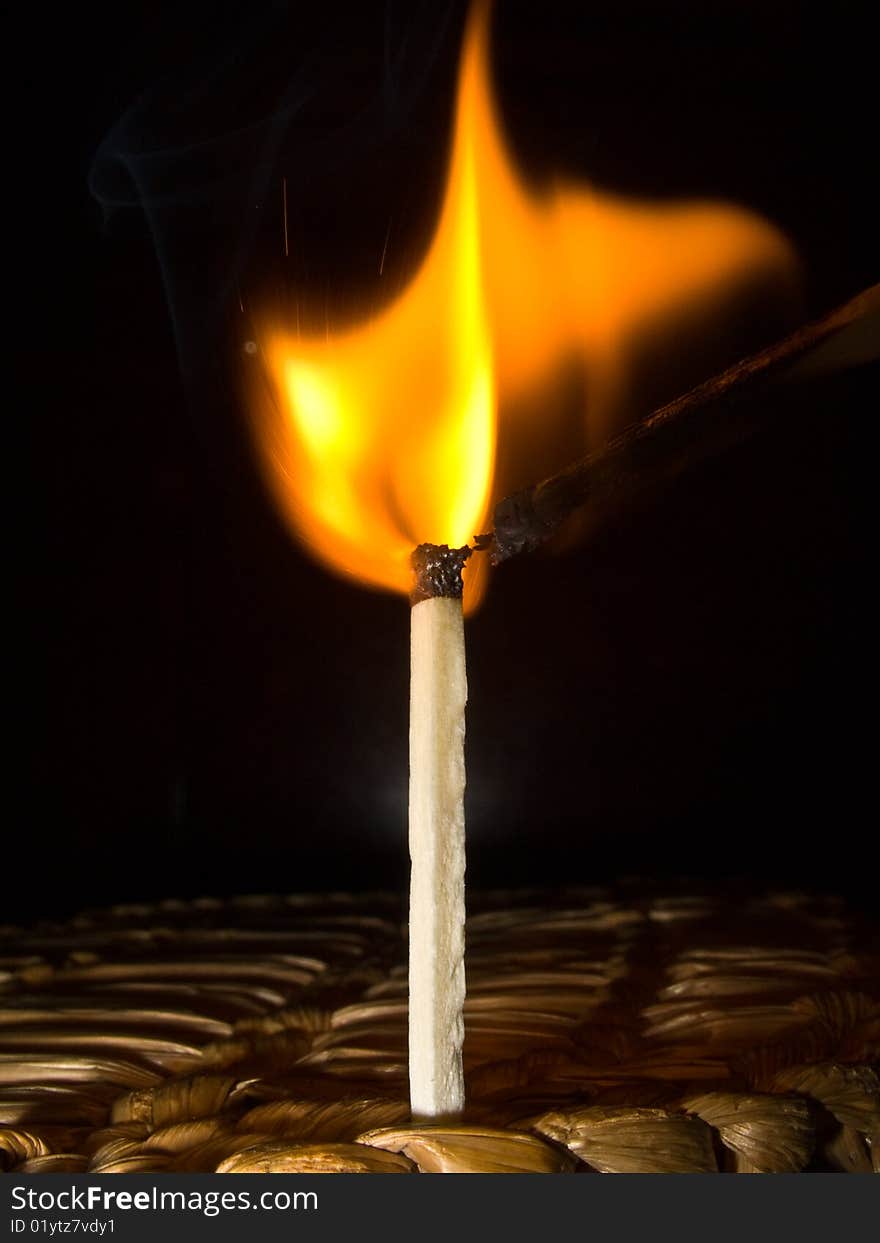 A macro photography of a burning match