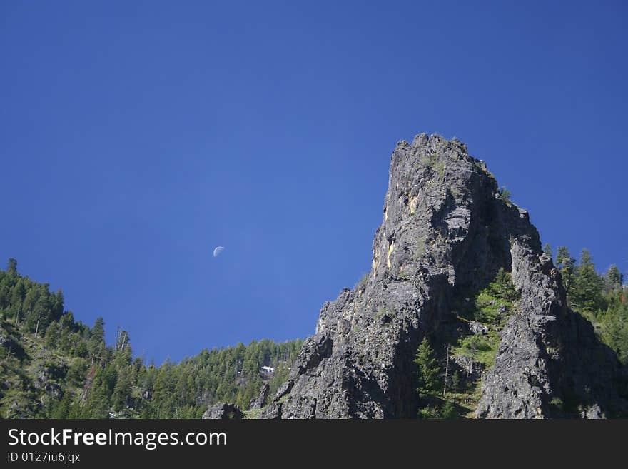 A rocky crag juts into the blue sky in the Idaho mountains. A rocky crag juts into the blue sky in the Idaho mountains.