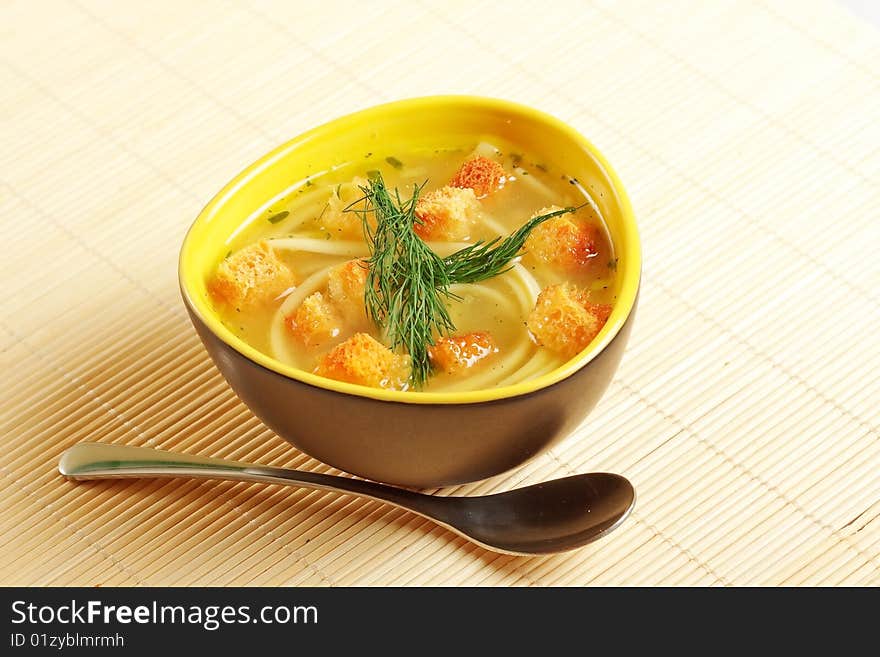 Close up image of a bowl of chicken noodle soup