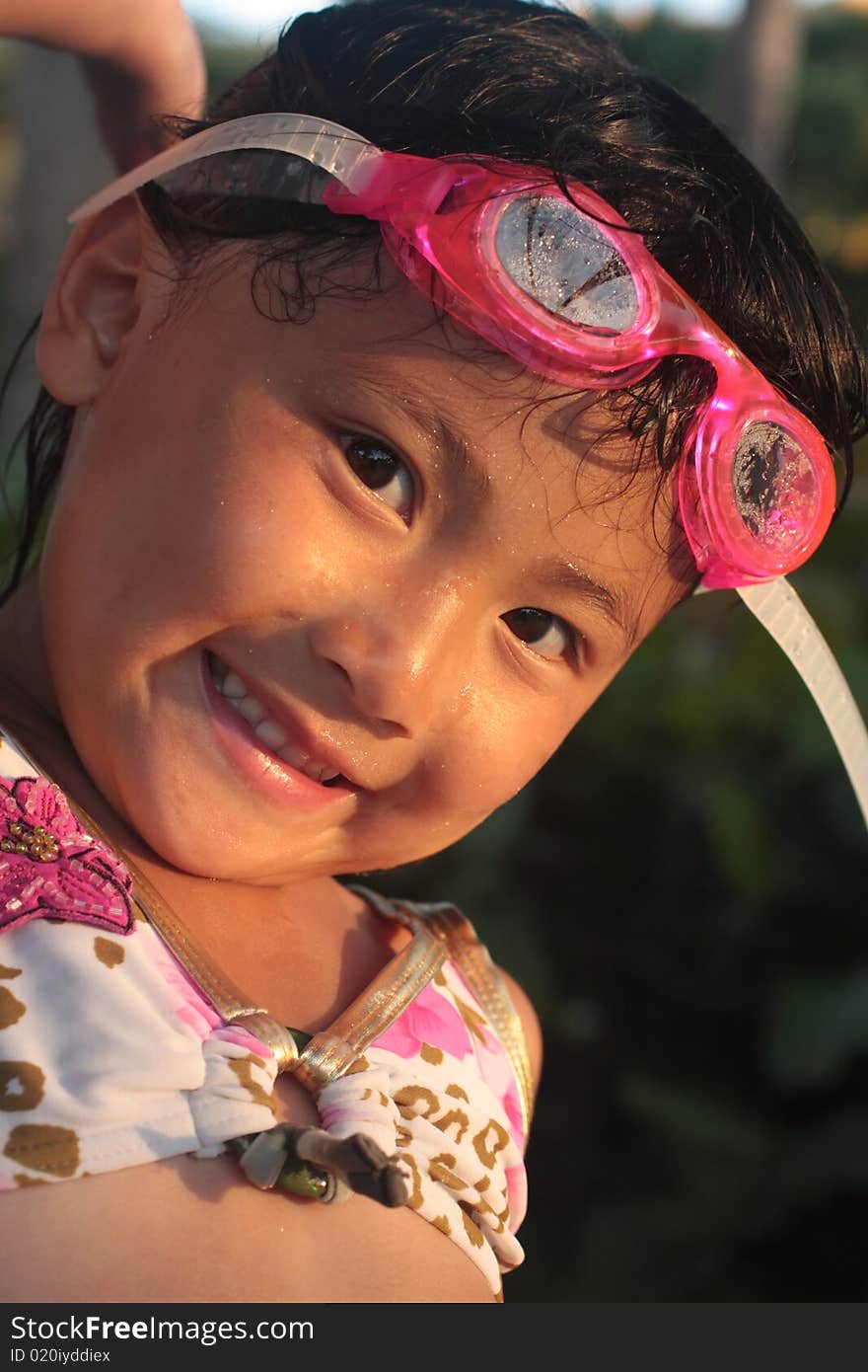 Little asian girl with pink goggles. Little asian girl with pink goggles