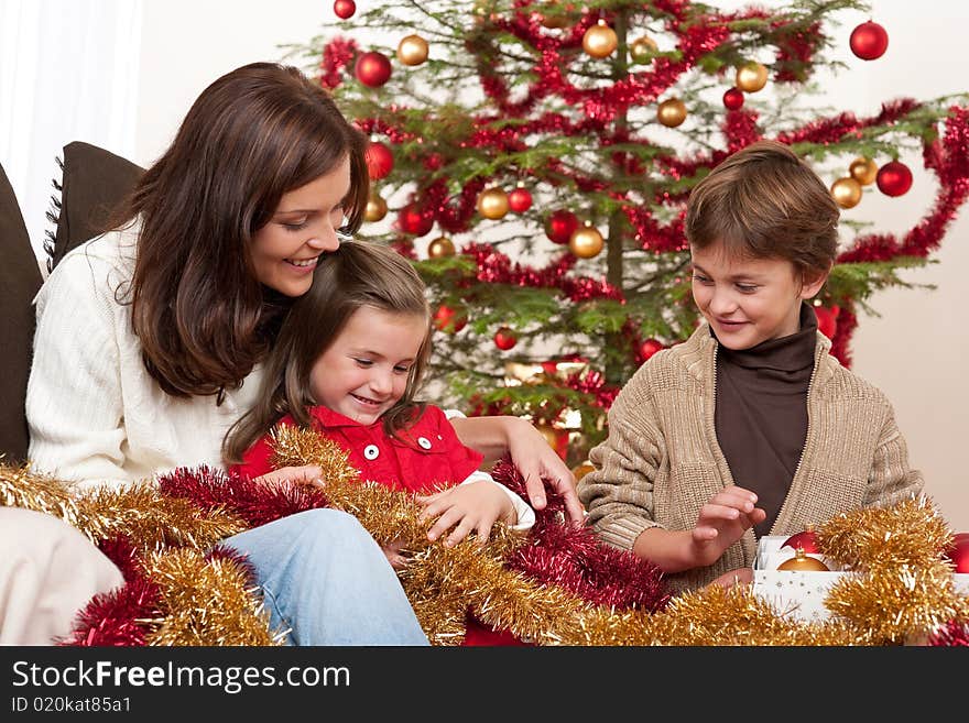 Happy family: mother with son and daughter on Christmas. Happy family: mother with son and daughter on Christmas