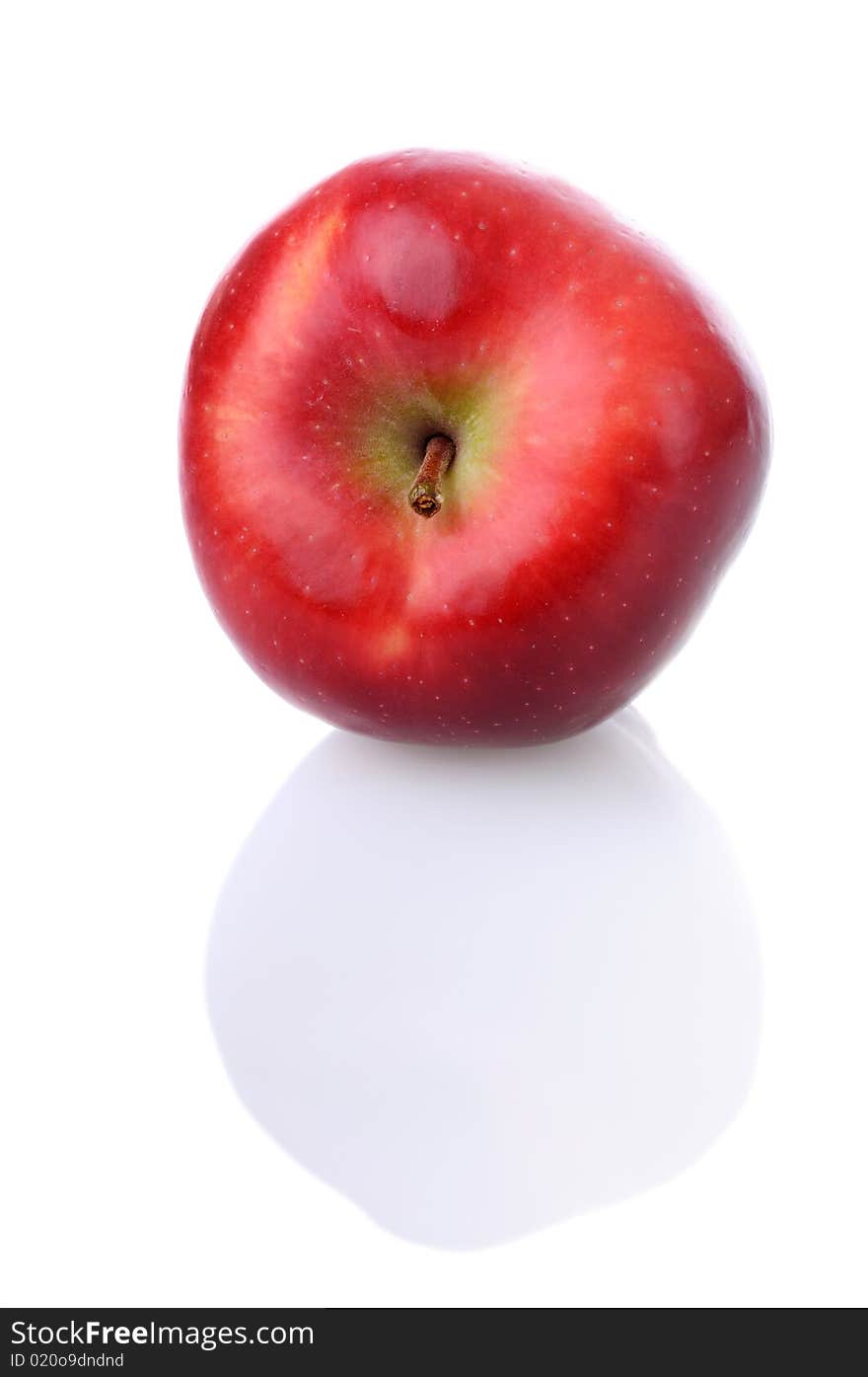 Fresh red apple with stem and reflection on white background