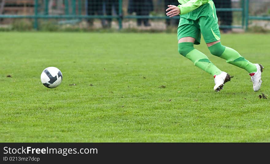 Soccer player running after the ball