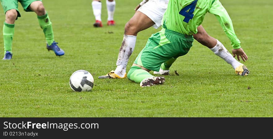 Soccer players running after the ball