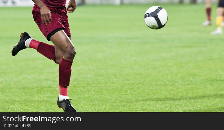 Soccer players running after the ball